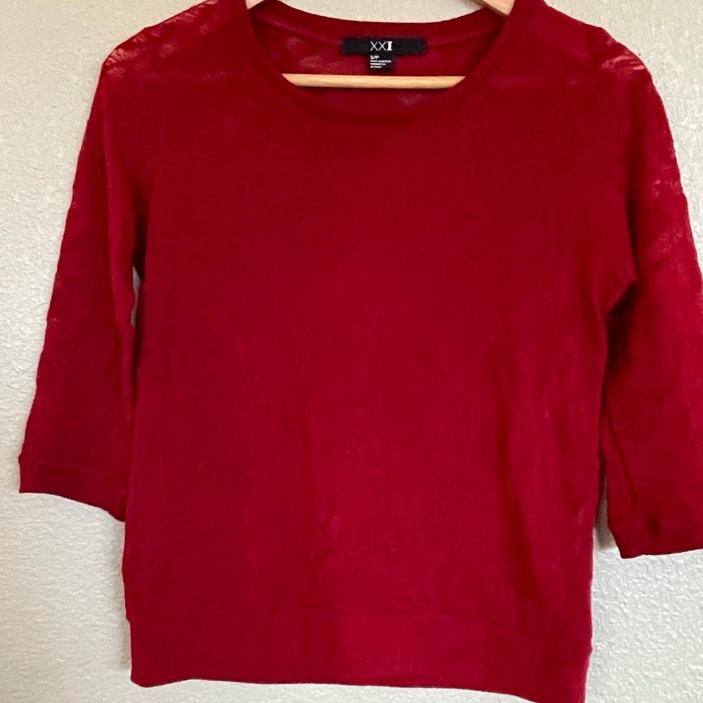 Red blouse with rose/flower pattern. Sheer in the light.